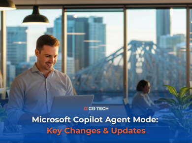 Business professional working on a laptop in a modern Brisbane office with a city skyline in the background.
